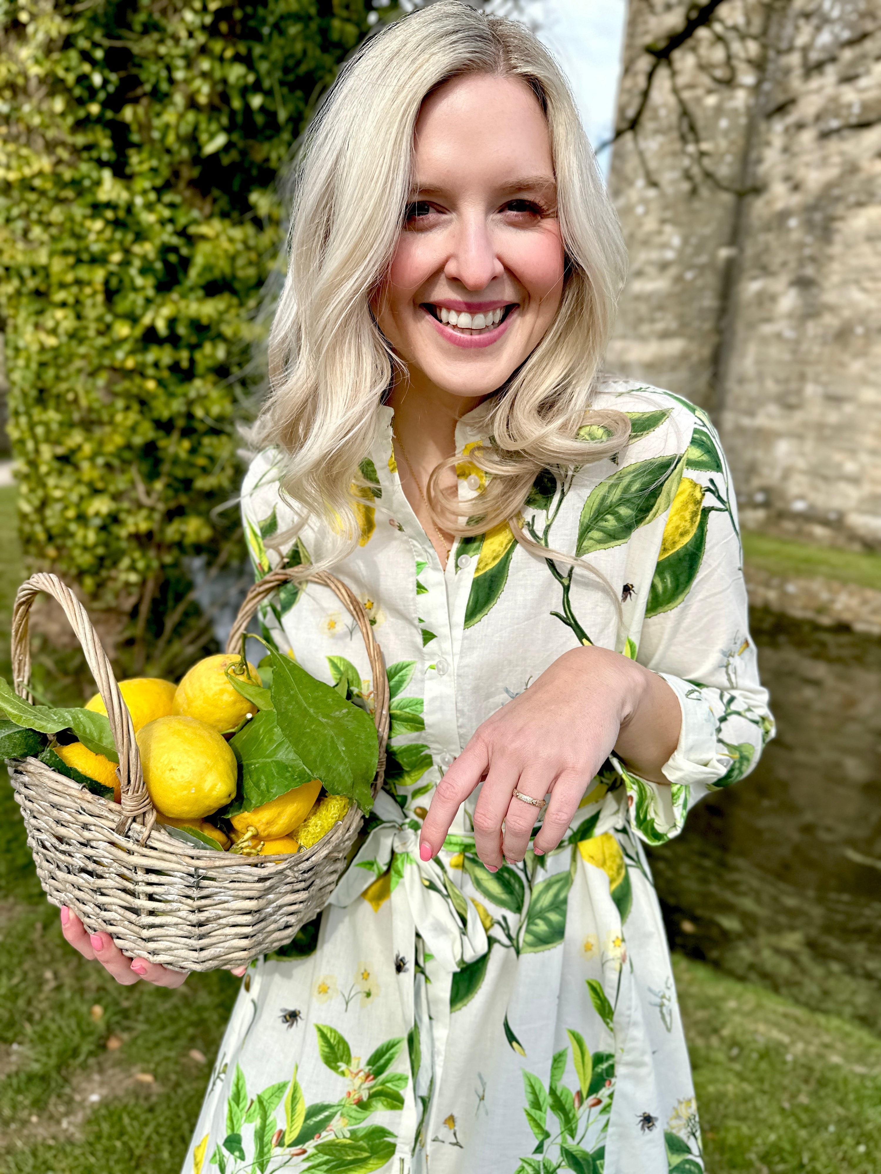 The Ally Cotton Dress in Citrus print from Rosehip Design is a versatile wardrobe staple with effortless charm. Featuring a button-down front, handy pockets, and a flattering half-frill hem, it offers both style and comfort. Wear it loose for a relaxed feel or cinch the waist with the tie belt for a more defined silhouette—perfect for any occasion.