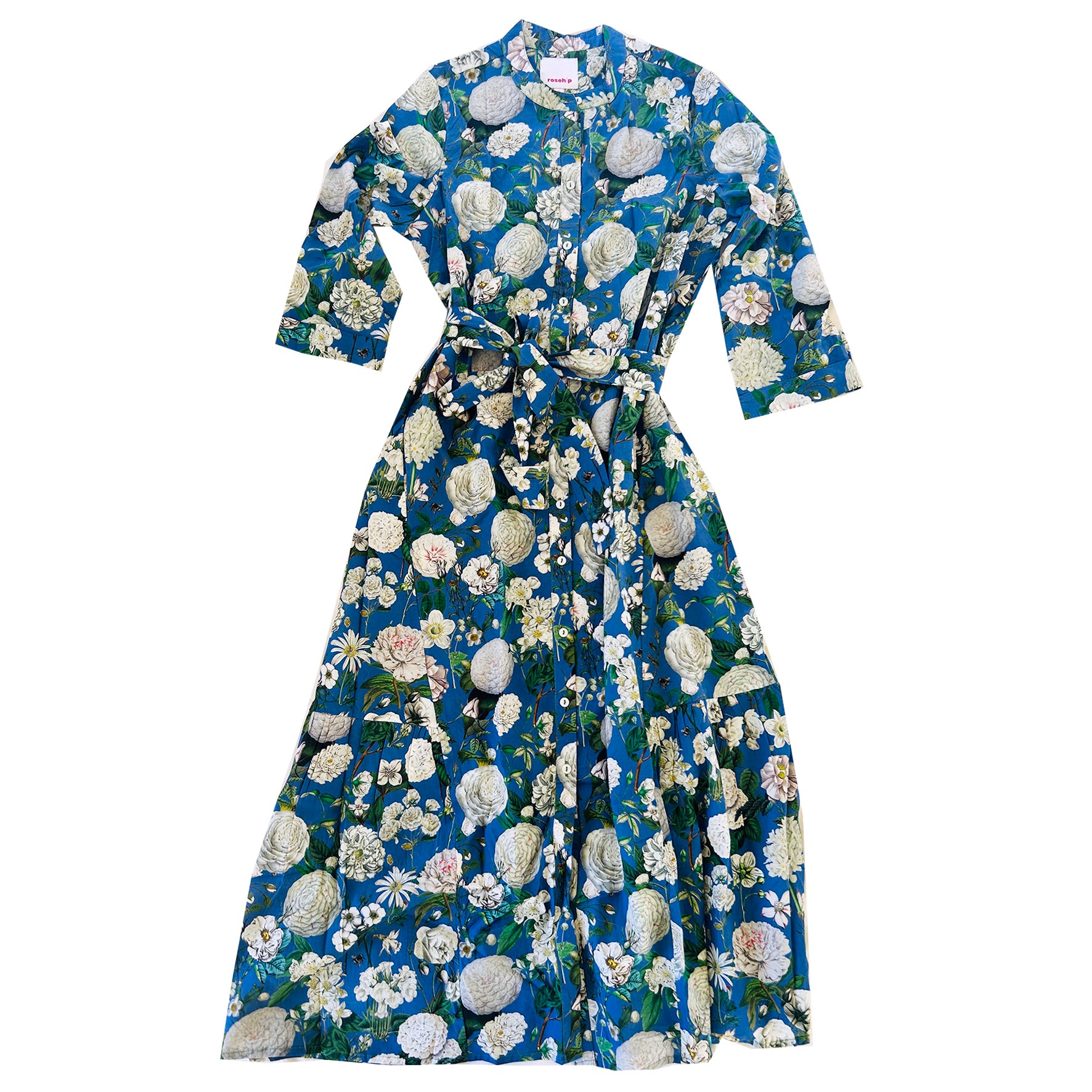 The Rosehip Design Ally Cotton Dress in Camelia Periwinkle is a versatile wardrobe staple with effortless charm. Featuring a button-down front, handy pockets, and a flattering half-frill hem, it offers both style and comfort. Wear it loose for a relaxed feel or cinch the waist with the tie belt for a more defined silhouette—perfect for any occasion.