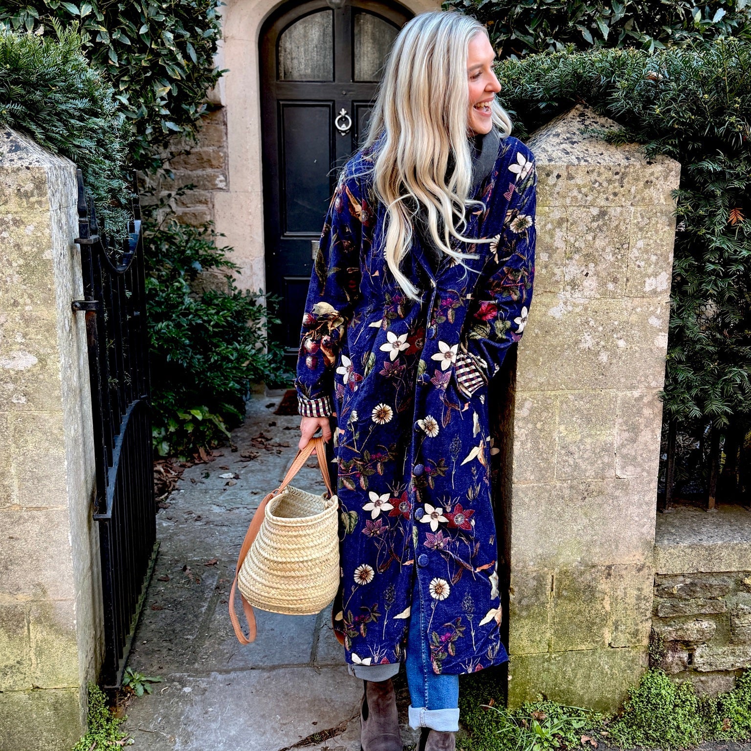 Wrap yourself in autumn warmth with this long velvet coat in a rich Rosehip Design Winter Floral that perfectly echoes the season. The beautiful plum tones on navy blue are perfect for this time of year. The soft velvet exterior is complemented by a classic check lining, adding a touch of style to its bold, modern silhouette. Luxuriously warm yet effortlessly wearable, it’s the perfect layer for crisp autumn days — whether you’re strolling through the countryside or heading into the city.