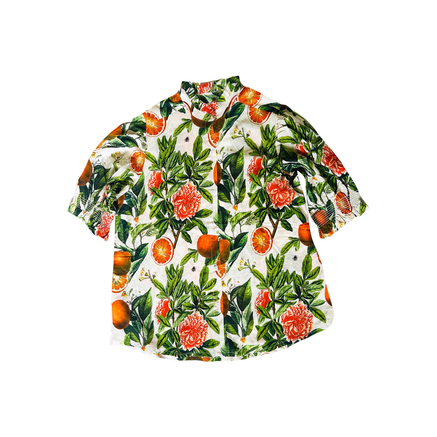 Rosehip Design Hannah Cotton Shirt in Blood Orange is a timeless blend of elegance and comfort. Made from soft cotton, it features a delicate frilled collar and intricate smocking on the sleeves for a touch of vintage charm. Designed for effortless styling, it pairs beautifully with the matching Bella Skirt.