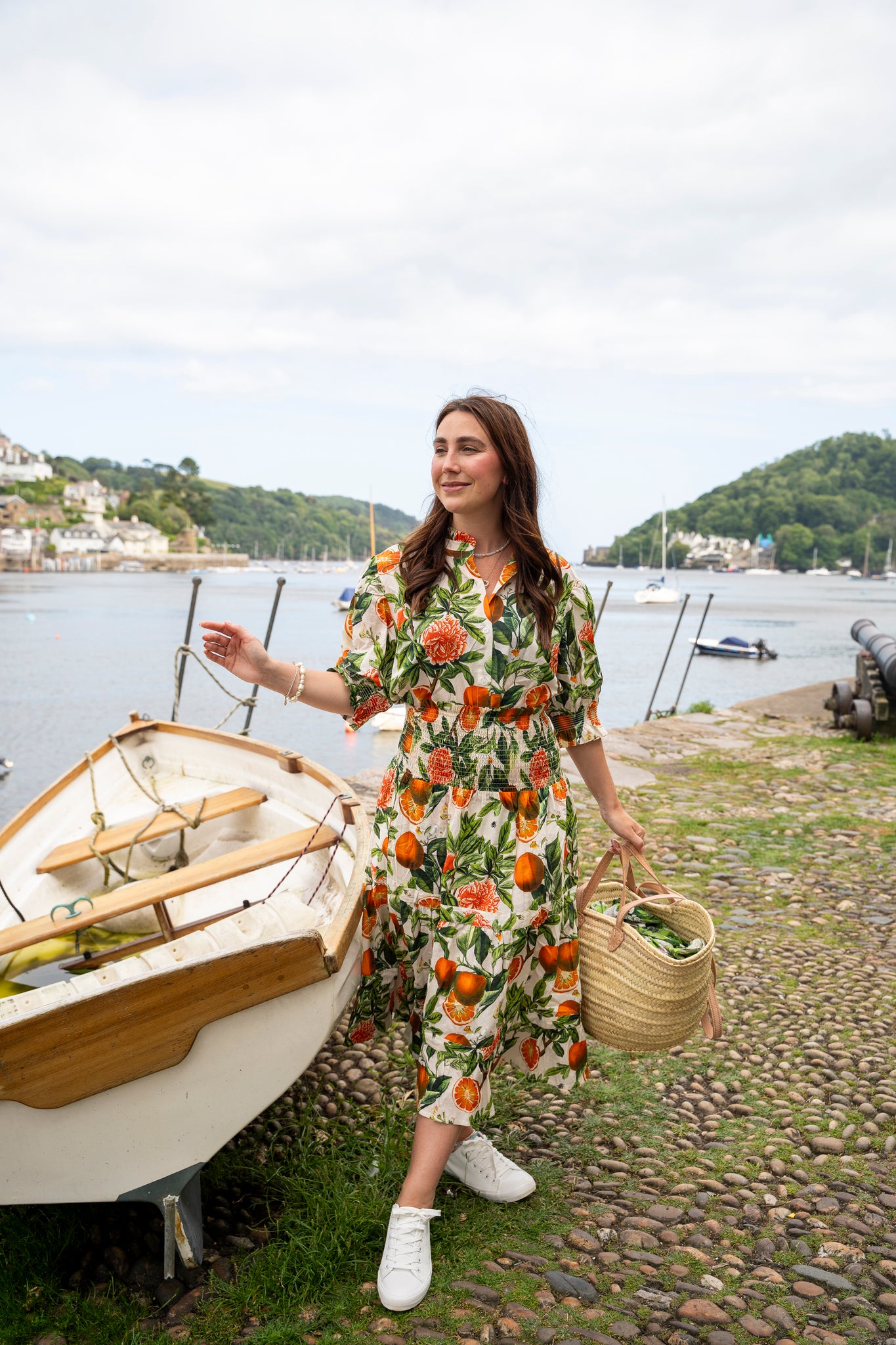 Rosehip Design Hannah Cotton Shirt in Blood Orange is a timeless blend of elegance and comfort. Made from soft cotton, it features a delicate frilled collar and intricate smocking on the sleeves for a touch of vintage charm. Designed for effortless styling, it pairs beautifully with the matching Bella Skirt.