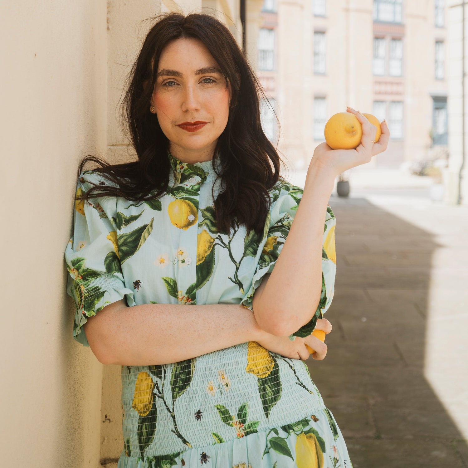 The Rosehip Design Hannah Cotton Shirt in Citrus Blue is a timeless blend of elegance and comfort. Made from soft cotton, it features a delicate frilled collar and intricate smocking on the sleeves for a touch of vintage charm. Designed for effortless styling, it pairs beautifully with the Bella Skirt