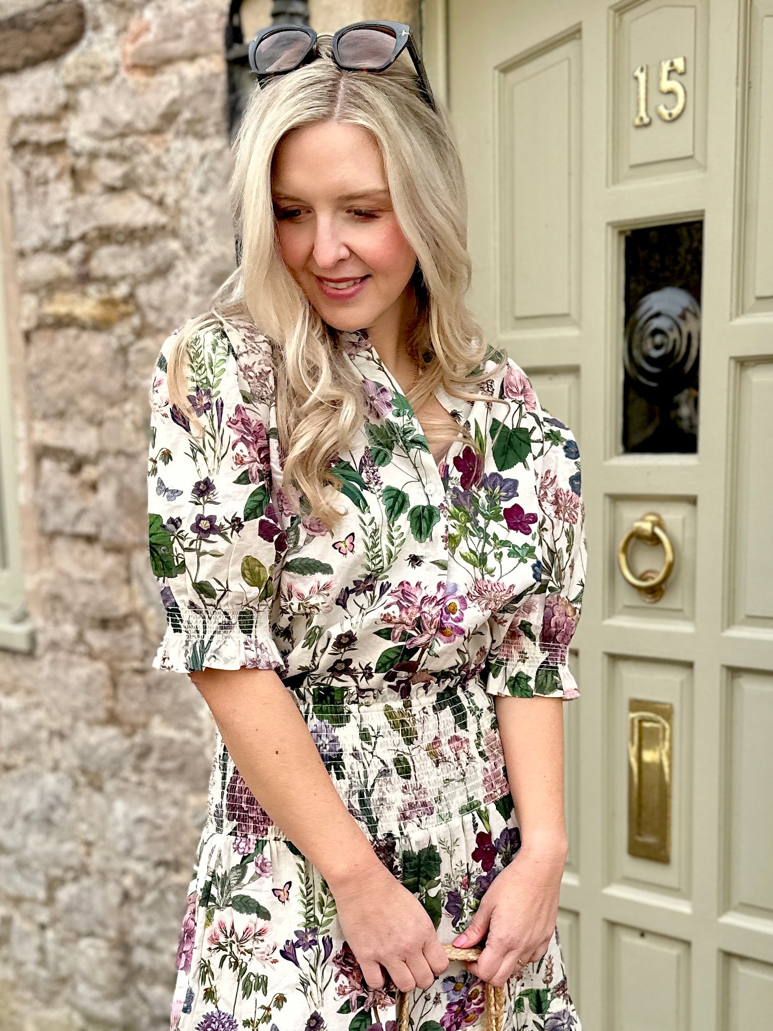 The Rosehip Design Hannah Cotton Shirt in Mallow is a timeless blend of elegance and comfort. Made from soft cotton, it features a delicate frilled collar and intricate smocking on the sleeves for a touch of vintage charm. Designed for effortless styling, it pairs beautifully with the Bella Skirt