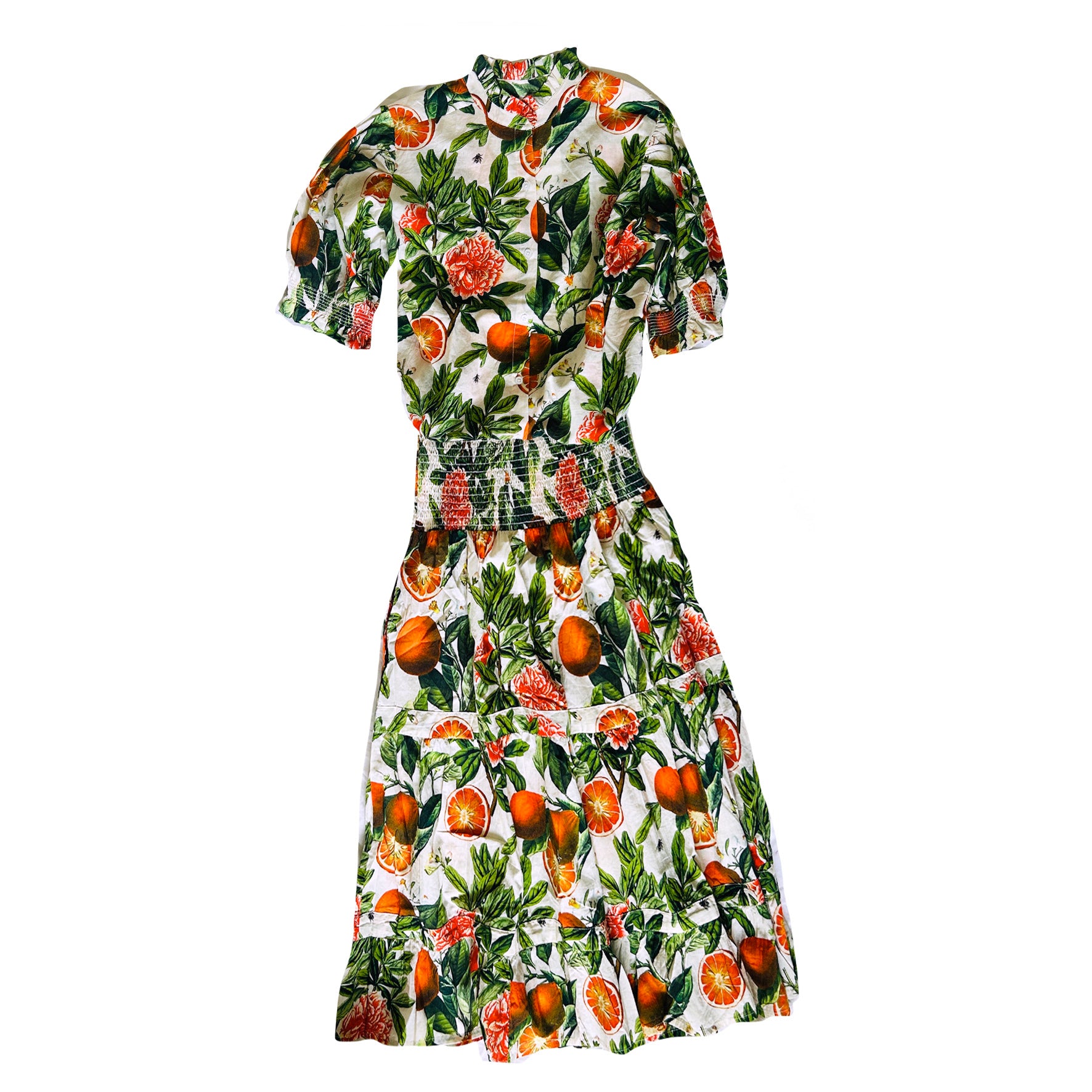 Rosehip Design Hannah Cotton Shirt in Blood Orange is a timeless blend of elegance and comfort. Made from soft cotton, it features a delicate frilled collar and intricate smocking on the sleeves for a touch of vintage charm. Designed for effortless styling, it pairs beautifully with the matching Bella Skirt.