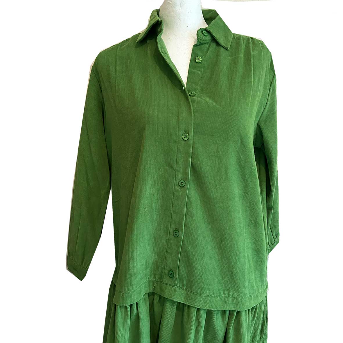 Rosehip Design Laura Dress - step into elegance with our Corduroy Maxi Dress, a perfect fusion of fashion and comfort in verdant Green. This dress boasts a gracefully dropped waist, creating a flattering and relaxed silhouette that effortlessly captures style with ease.