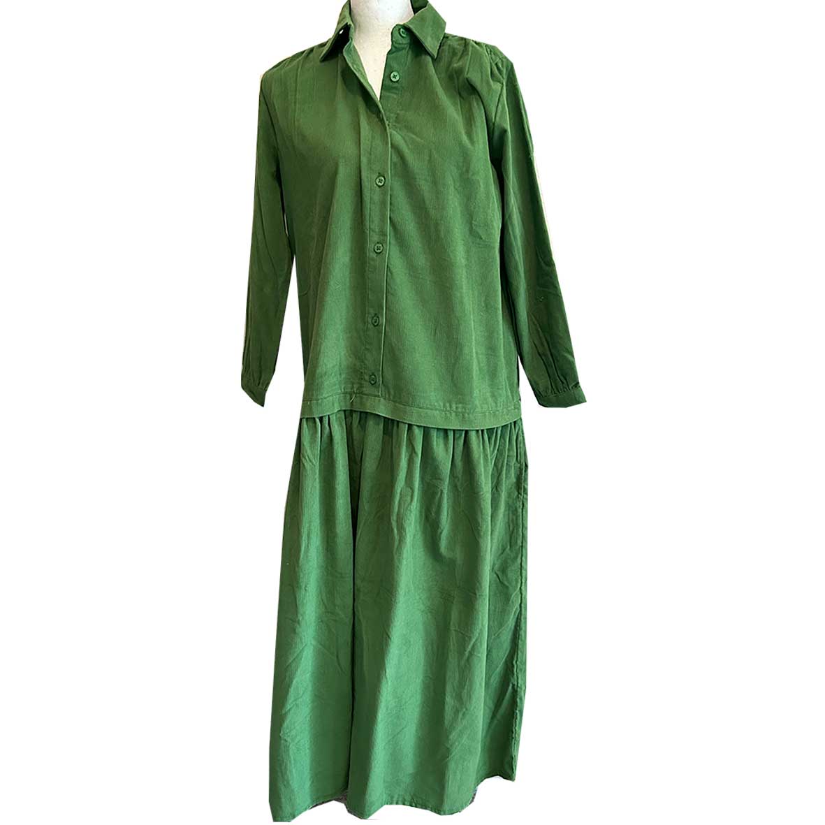 Rosehip Design Laura Dress - step into elegance with our Corduroy Maxi Dress, a perfect fusion of fashion and comfort in verdant Green. This dress boasts a gracefully dropped waist, creating a flattering and relaxed silhouette that effortlessly captures style with ease.