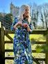 Spring into style with the Rosehip Design Lydia Linen Dress in Spring Blues design. This shirtwaister dress features a beautiful floral design and a fabric tie belt for a flattering fit. With its long sleeves and button-up front, this dress is the perfect combination of comfort and chic. Ready to bloom in your wardrobe!