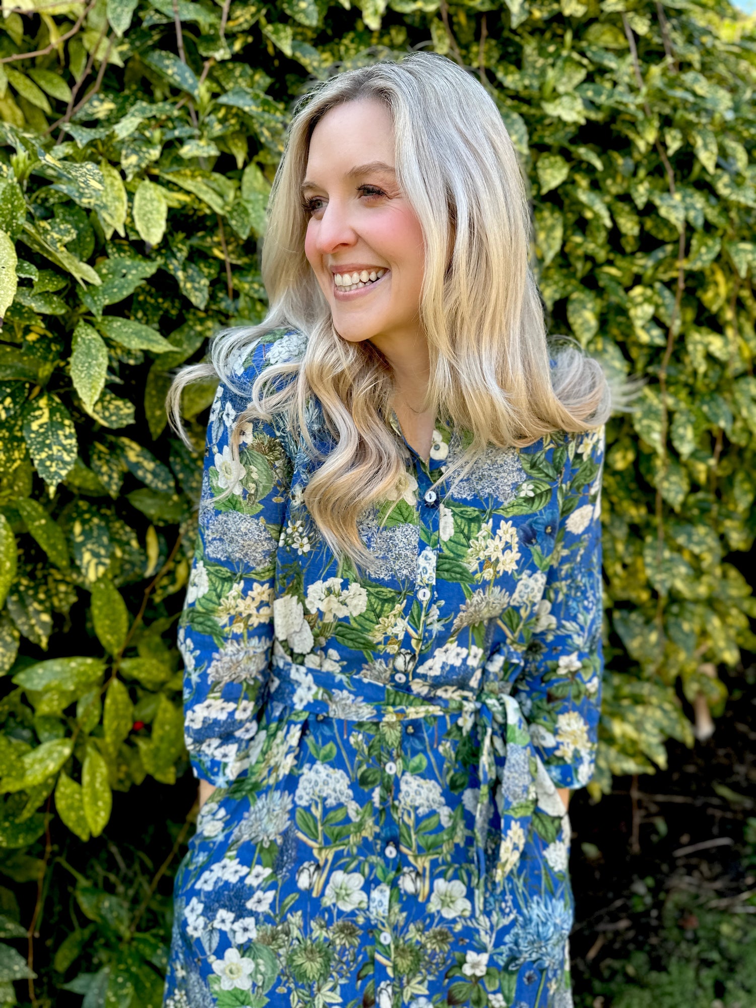 Spring into style with the Rosehip Design Lydia Linen Dress in Spring Blues design. This shirtwaister dress features a beautiful floral design and a fabric tie belt for a flattering fit. With its long sleeves and button-up front, this dress is the perfect combination of comfort and chic. Ready to bloom in your wardrobe!