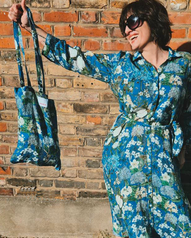 Spring into style with the Rosehip Design Lydia Linen Dress in Spring Blues design. This shirtwaister dress features a beautiful floral design and a fabric tie belt for a flattering fit. With its long sleeves and button-up front, this dress is the perfect combination of comfort and chic. Ready to bloom in your wardrobe!