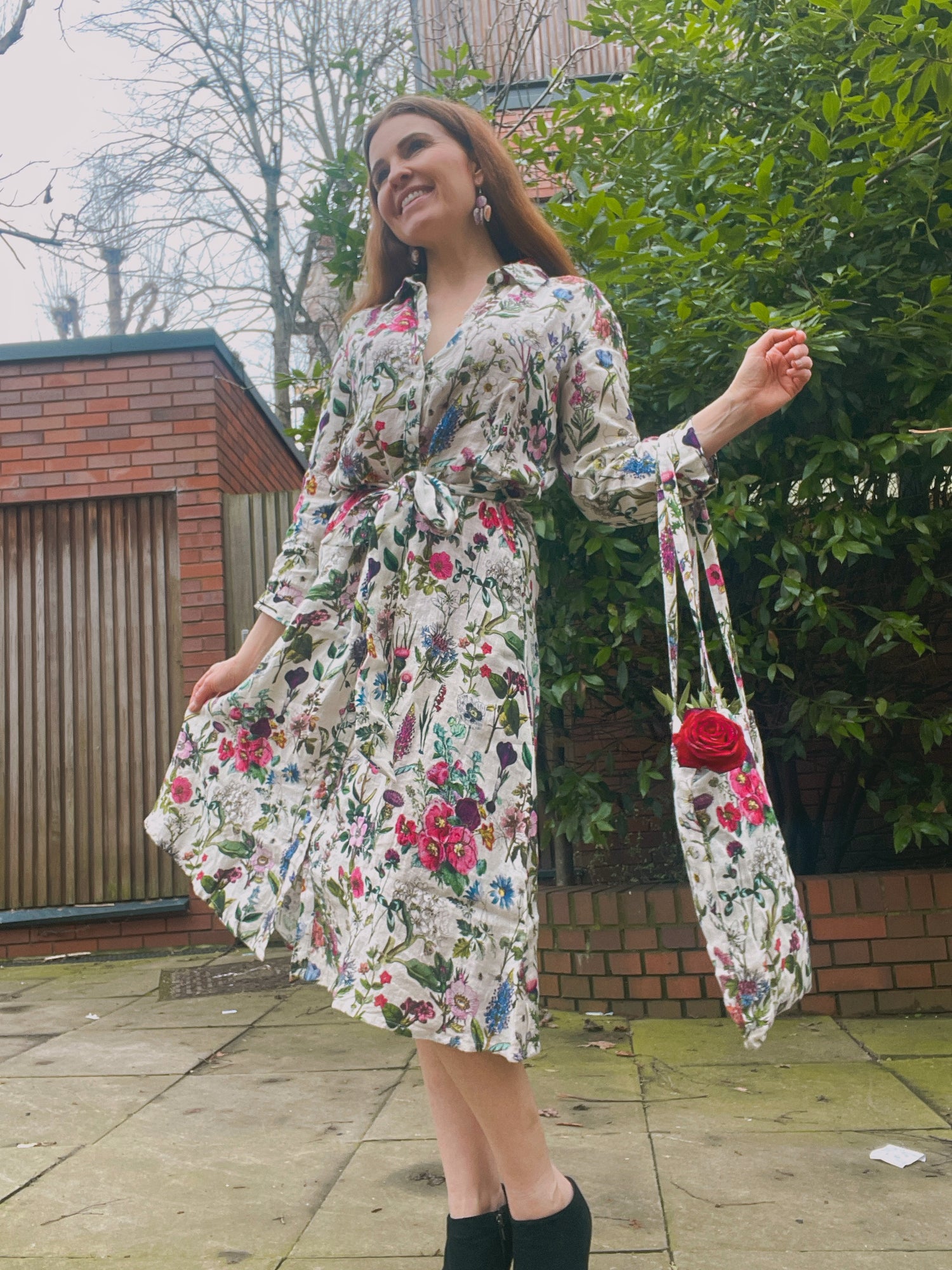 Spring into style with the Rosehip Design Lydia Linen Dress in Barcelona design. This shirtwaister dress features a beautiful floral design and a fabric tie belt for a flattering fit. With its long sleeves and button-up front, this dress is the perfect combination of comfort and chic. Ready to bloom in your wardrobe!