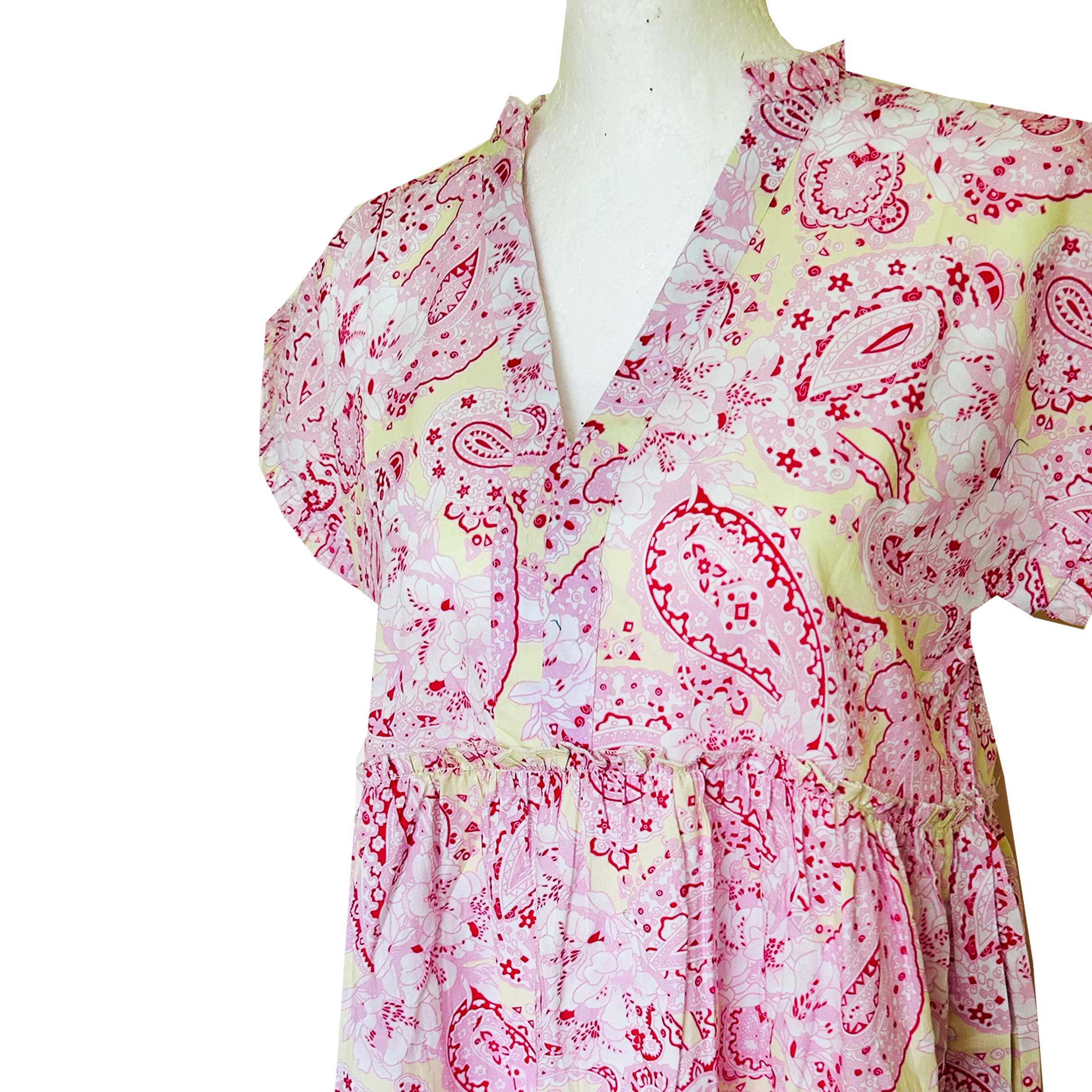 Rosehip Design Olivia is a beautiful cotton dress in our stylish pink and yellow Paisley Rhubarb print. The Olivia dress has short, capped sleeves with a rough frill. The skirt is tiered and has pockets.