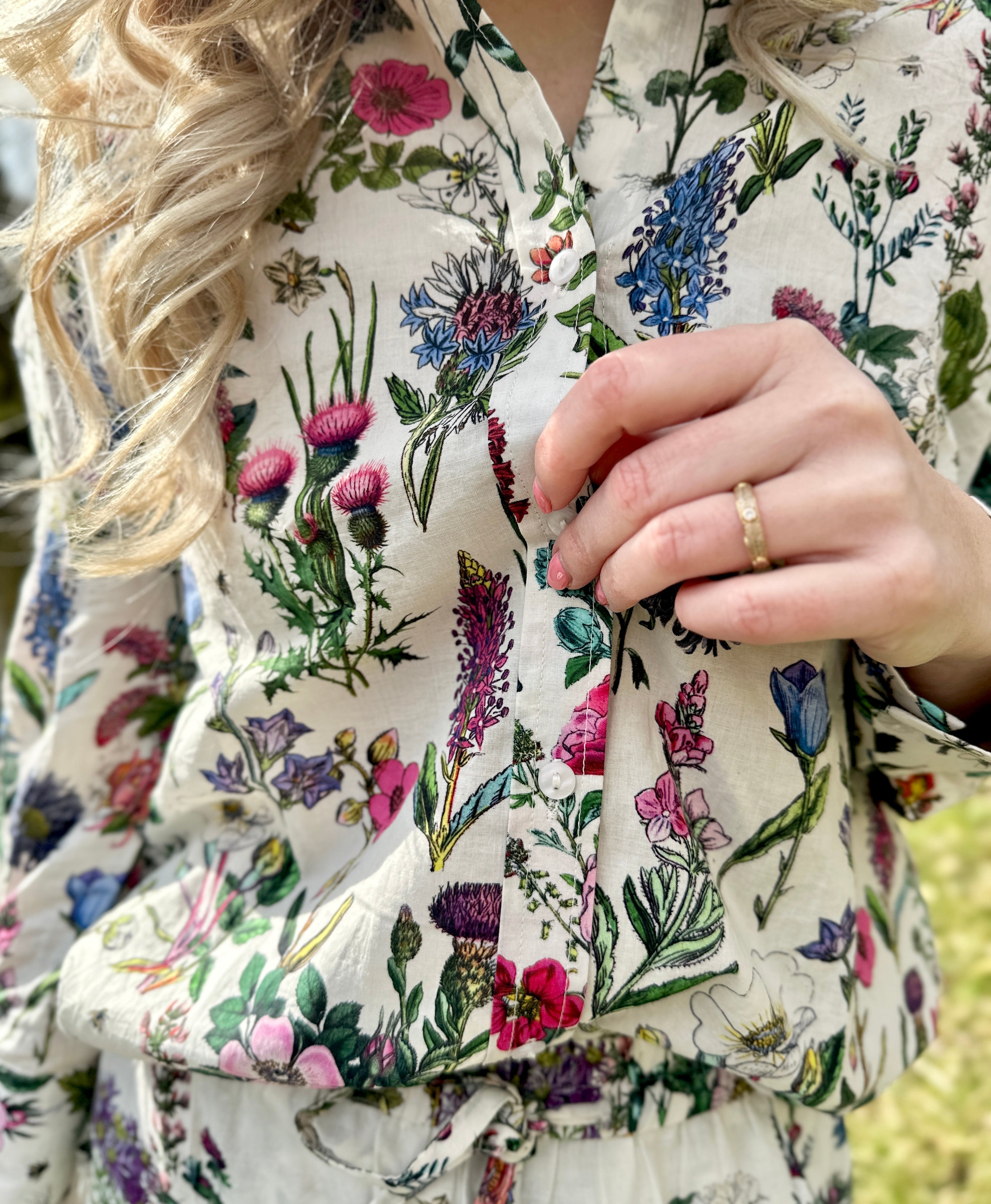 The Rosehip Design Sarah Cotton Shirt is a timeless wardrobe staple, made of soft cotton. It features a classic button-down front, elegant sleeves that end just before the wrist, and a gently curved hem for a relaxed yet polished look.
Featuring our vibrant Barcelona print, this shirt is a celebration of summer, bursting with lively hues and intricate floral patterns. Perfect for warm-weather styling, it pairs beautifully with the matching Sally Skirt for a coordinated ensemble, or just jeans.