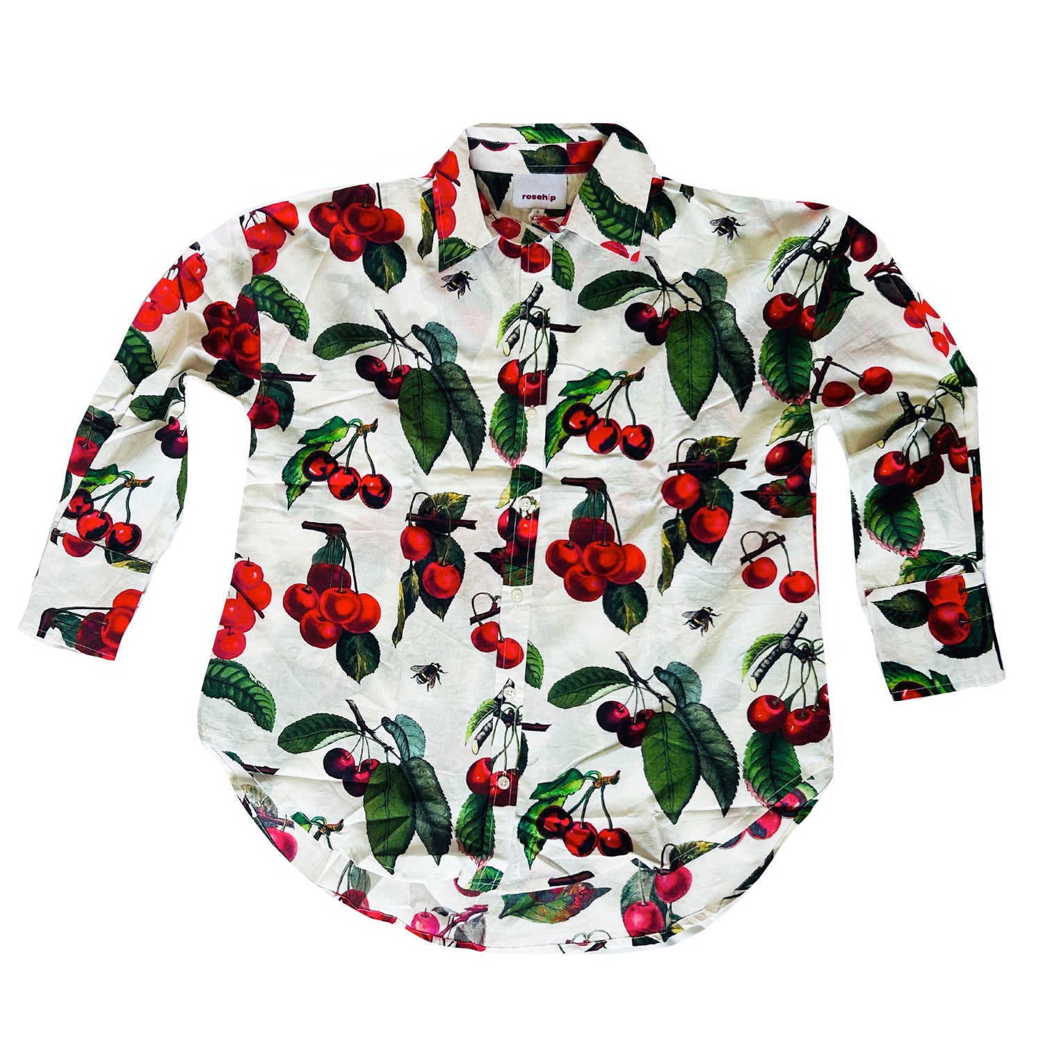 Rosehip Design Sarah Cotton Shirt is a timeless wardrobe staple, made of soft cotton. Featuring a classic button-down front, elegant sleeves that end just before the wrist, and a gently curved hem for a relaxed yet polished look.
The edible Cherries print is a celebration of summer, bursting with lively hues and intricate floral patterns. Perfect for warm-weather styling, it pairs beautifully with the matching Sally Skirt for a coordinated ensemble or can be effortlessly styled with jeans or shorts.