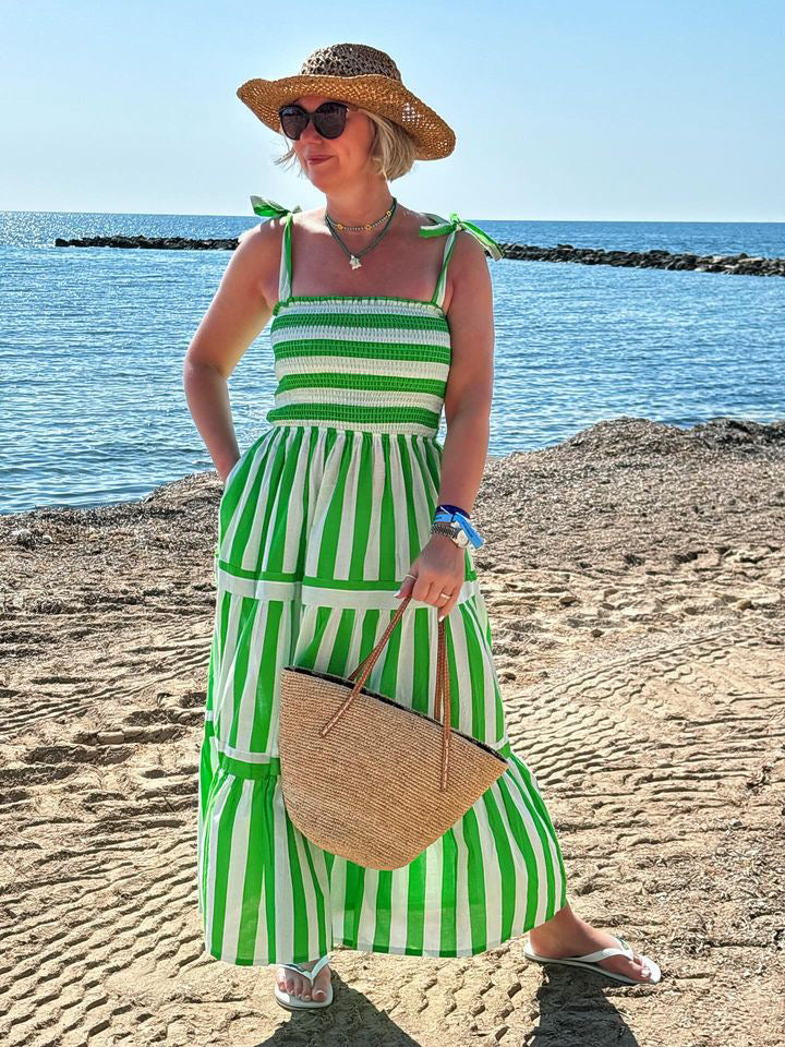 Rosehip Design Tropez Sundress is a gorgeous Summer dress featuring a shirred top with straps and a long flowing skirt with pockets. Perfect holiday wear in our dazzling Verde green and white stripes design.