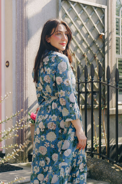 The Ally Cotton Dress in Camelia Periwinkle from Rosehip Design is a versatile wardrobe staple with effortless charm. Featuring a button-down front, handy pockets, and a flattering half-frill hem, it offers both style and comfort. Wear it loose for a relaxed feel or cinch the waist with the tie belt for a more defined silhouette—perfect for any occasion.