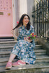 The Ally Cotton Dress in Camelia Periwinkle from Rosehip Design is a versatile wardrobe staple with effortless charm. Featuring a button-down front, handy pockets, and a flattering half-frill hem, it offers both style and comfort. Wear it loose for a relaxed feel or cinch the waist with the tie belt for a more defined silhouette—perfect for any occasion.