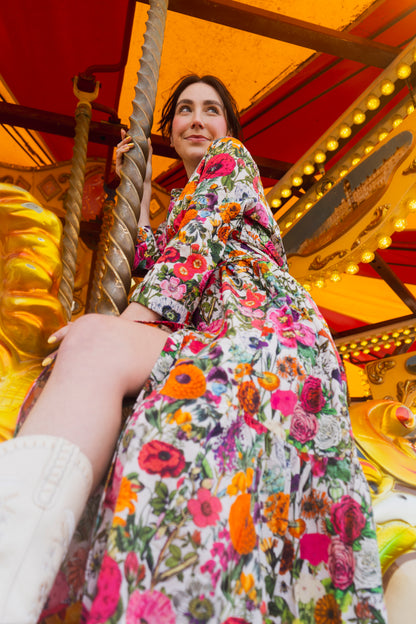 Rosehip Design Ally Cotton Dress is a versatile wardrobe staple with effortless charm. Featuring a button-down front, handy pockets, and a flattering half-frill hem, it offers both style and comfort.

Wear it loose for a relaxed feel or cinch the waist with the tie belt for a more defined silhouette—perfect for any occasion.

Carnival print is a riot of colour.