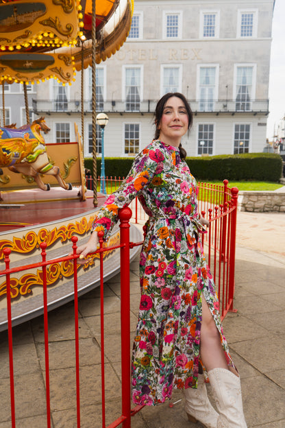Rosehip Design Ally Cotton Dress is a versatile wardrobe staple with effortless charm. Featuring a button-down front, handy pockets, and a flattering half-frill hem, it offers both style and comfort.

Wear it loose for a relaxed feel or cinch the waist with the tie belt for a more defined silhouette—perfect for any occasion.

Carnival print is a riot of colour.