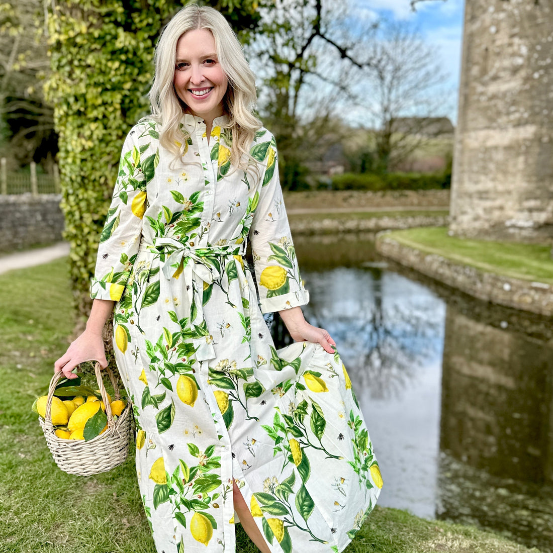 The Ally Cotton Dress in Citrus print from Rosehip Design is a versatile wardrobe staple with effortless charm. Featuring a button-down front, handy pockets, and a flattering half-frill hem, it offers both style and comfort. Wear it loose for a relaxed feel or cinch the waist with the tie belt for a more defined silhouette—perfect for any occasion.
