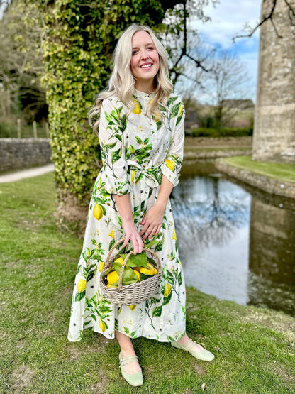 staple with effortless charm. Featuring a button-down front, handy pockets, and a flattering half-frill hem, it offers both style and comfort. Wear it loose for a relaxed feel or cinch the waist with the tie belt for a more defined silhouette—perfect for any occasion.