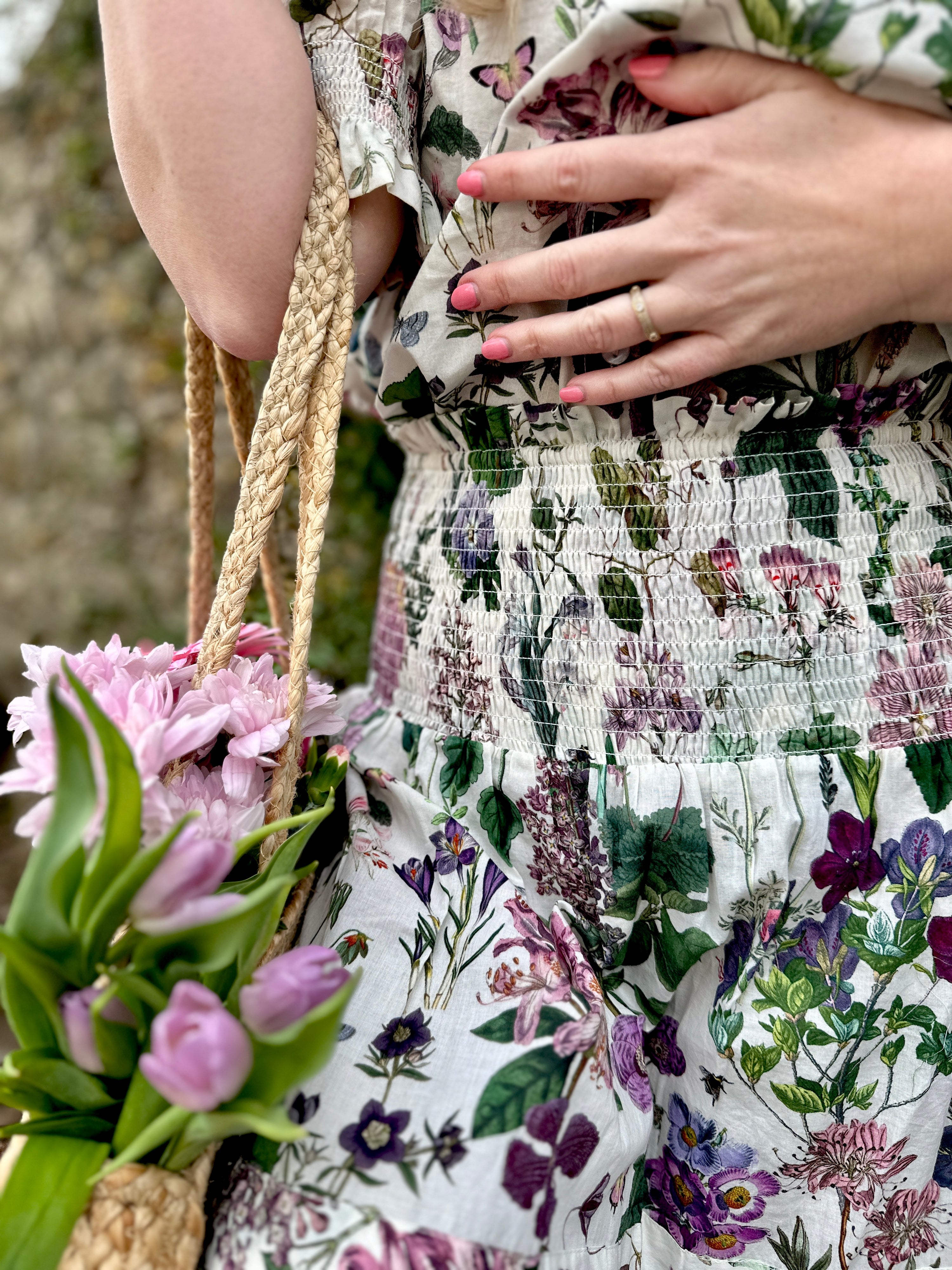 Rosehip Design Bella Cotton Skirt in our ever popular Mallow design is a beautifully feminine and effortlessly comfortable piece, perfect for Summer. Made from soft, breathable cotton it features a flattering shirred waistband that provides a flexible, comfortable fit. The tiered design adds movement &amp; a touch of romantic charm, while the addition of practical pockets makes it as functional as it is stylish.
Whether paired with a simple tee or the coordinating Hannah Shirt, the Bella is a versatile staple.