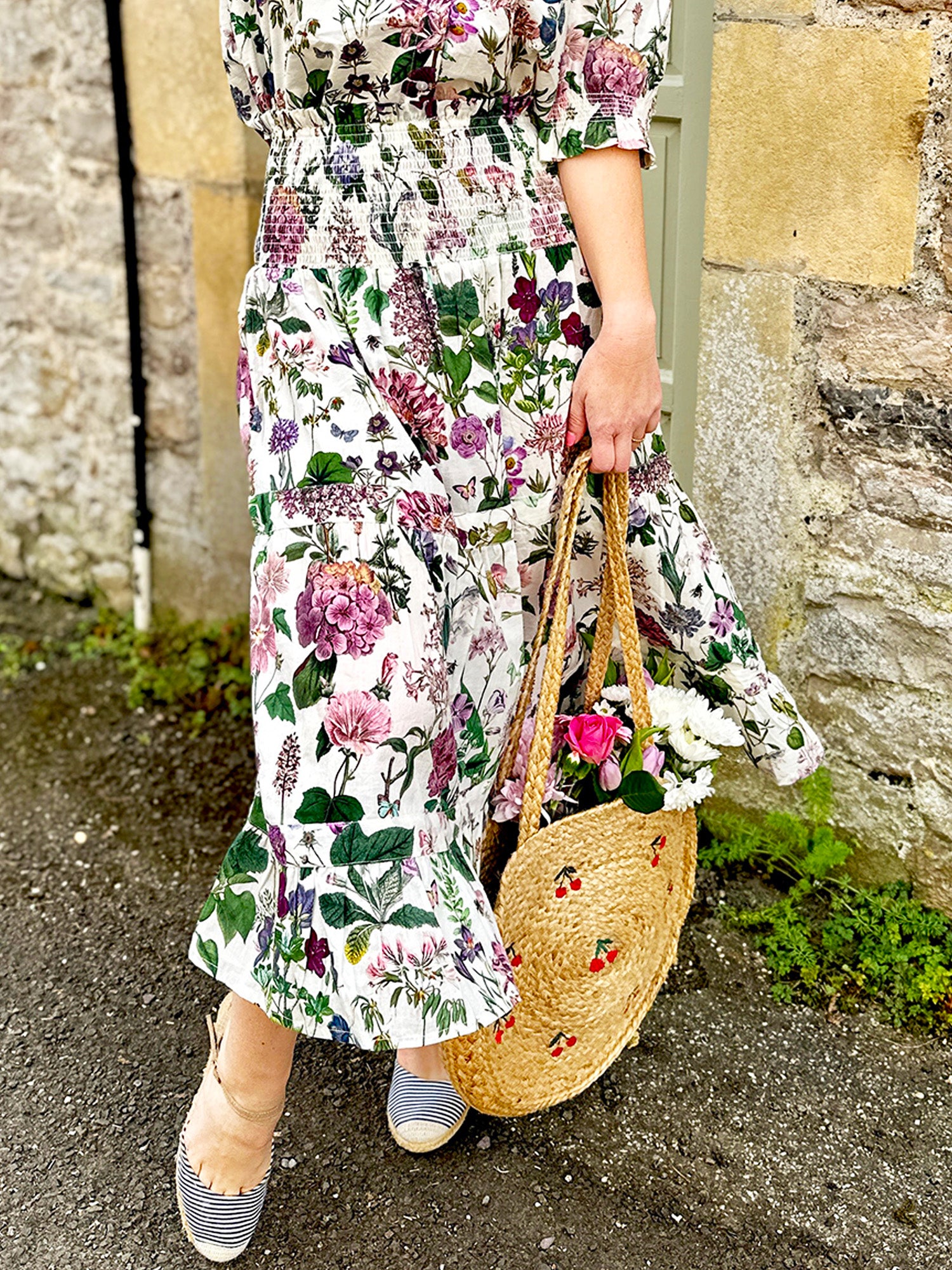 Rosehip Design Bella Cotton Skirt in our ever popular Mallow design is a beautifully feminine and effortlessly comfortable piece, perfect for Summer. Made from soft, breathable cotton it features a flattering shirred waistband that provides a flexible, comfortable fit. The tiered design adds movement &amp; a touch of romantic charm, while the addition of practical pockets makes it as functional as it is stylish.
Whether paired with a simple tee or the coordinating Hannah Shirt, the Bella is a versatile staple.