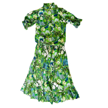 Rosehip Design Bella Cotton Skirt in our Spring Greens design is a beautifully feminine, effortlessly comfortable piece, perfect for Summer. Made from soft, breathable cotton with a flattering, flexible shirred waistband. The tiered design adds movement and a touch of romantic charm, while the addition of practical pockets makes it as functional as it is stylish.

Whether paired with a simple tee or the coordinating Hannah Shirt, it&