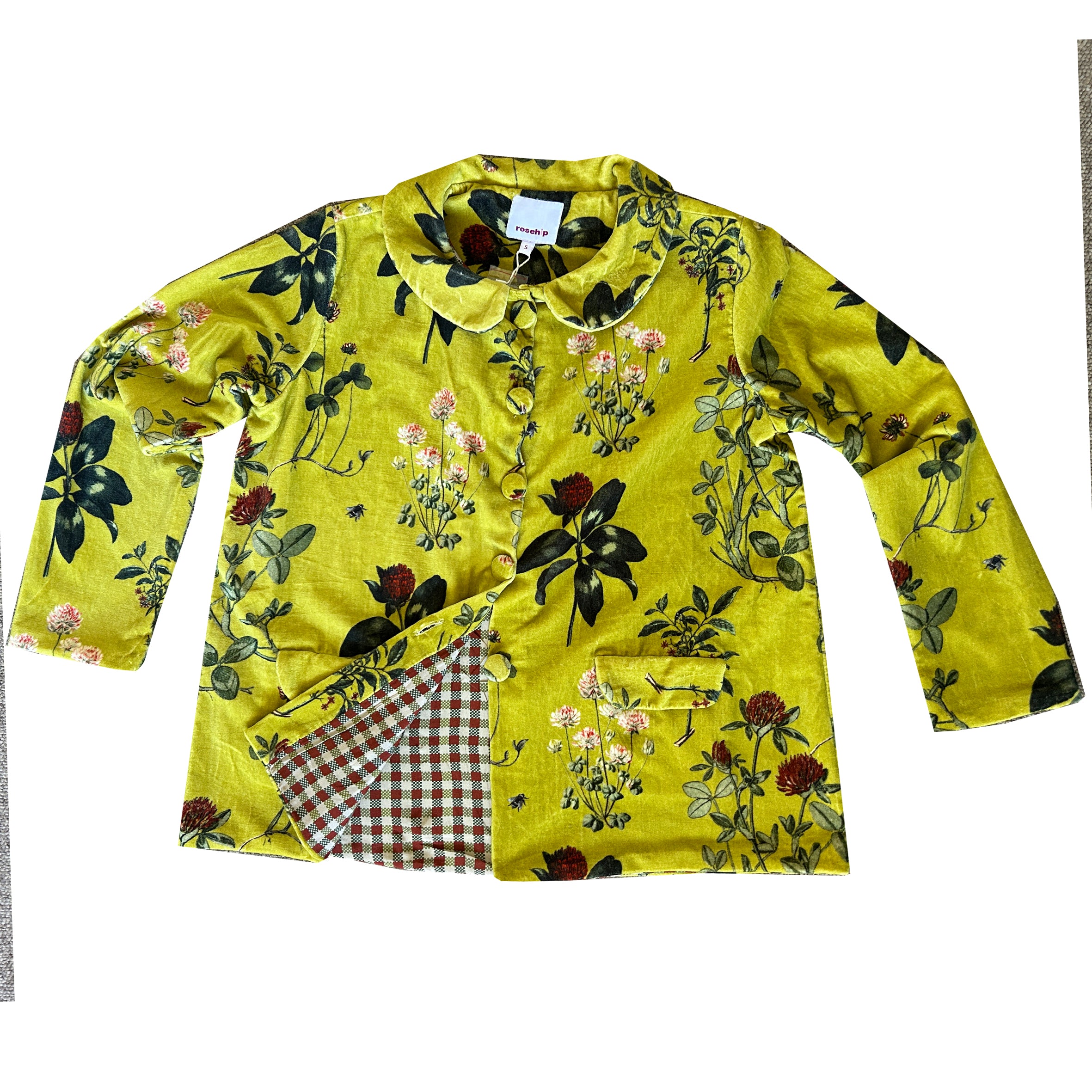 Wrap yourself in effortless elegance with our Rosehip Design Brompton Velvet Coat, designed in a rich velvet fabric that feels as luxurious as it looks. This statement coat features a playful autumn floral print, bringing warmth and charm to your seasonal wardrobe. Fully lined in co-ordinating checks, it offers a refined contrast and a polished finish inside and out.