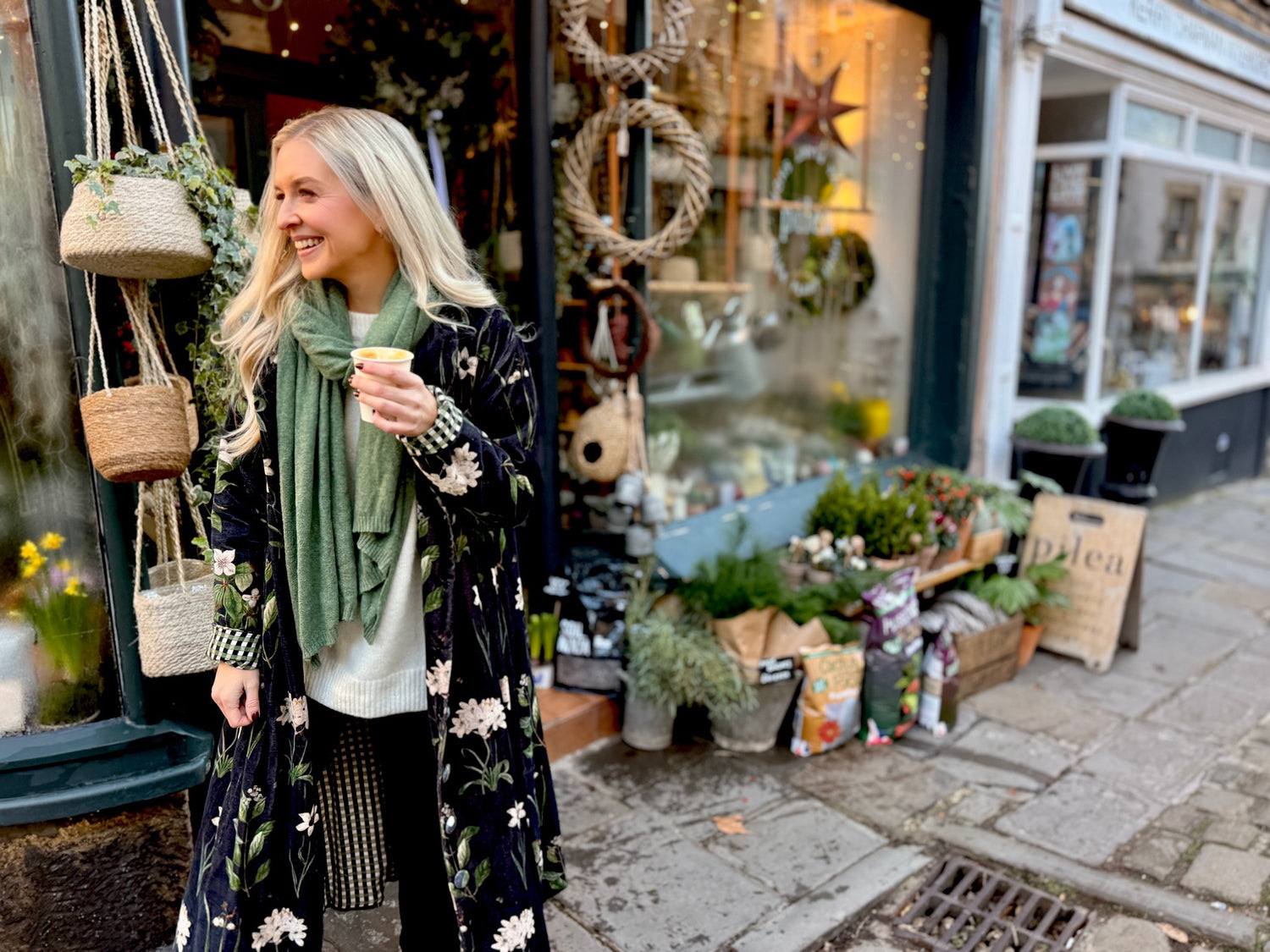 Wrap yourself in autumn warmth with this long velvet coat in a rich Rosehip Design Winter Floral that perfectly echoes the season. The beautiful plum tones on navy blue are perfect for this time of year. The soft velvet exterior is complemented by a classic check lining, adding a touch of style to its bold, modern silhouette. Luxuriously warm yet effortlessly wearable, it’s the perfect layer for crisp autumn days — whether you’re strolling through the countryside or heading into the city.