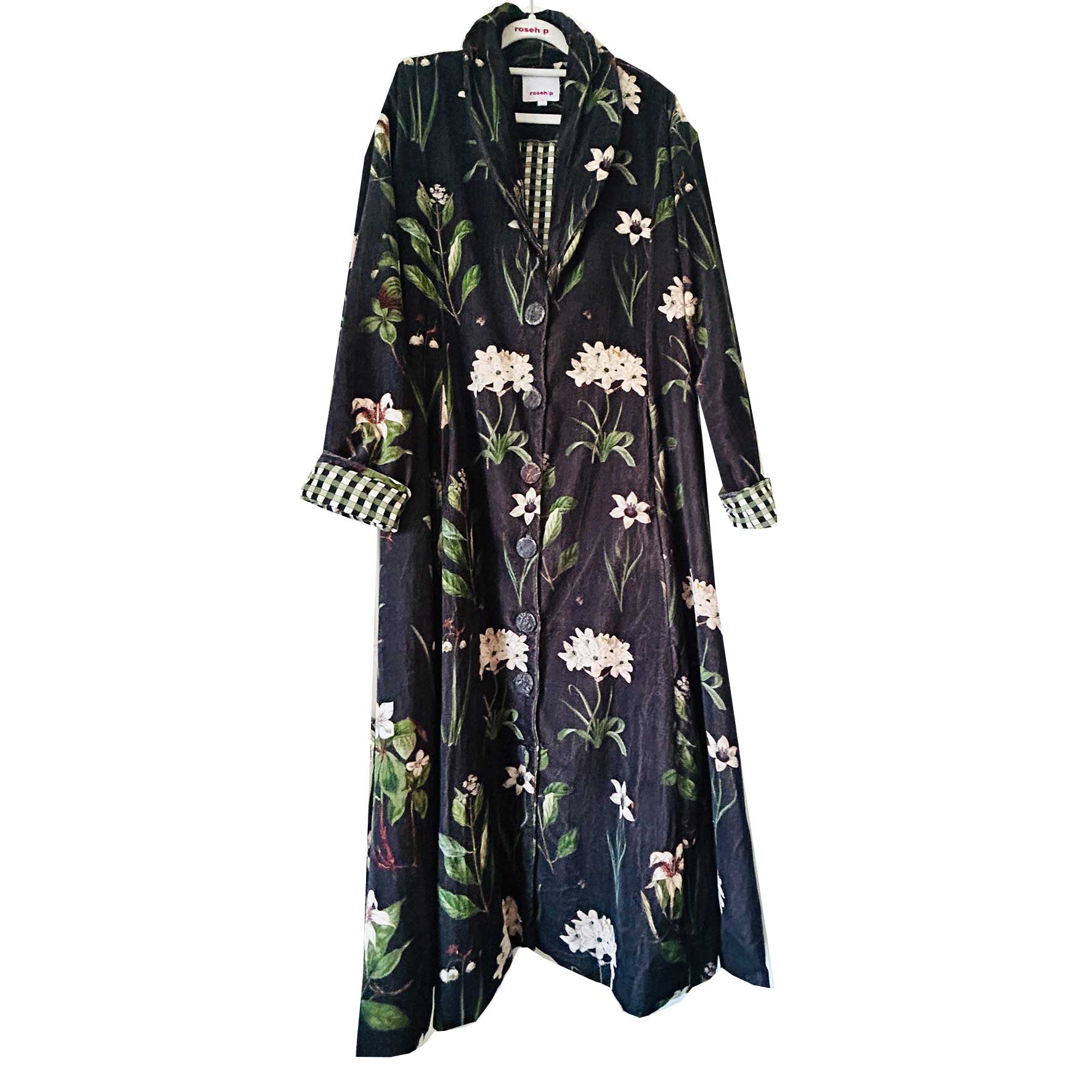 Wrap yourself in autumn warmth with this long velvet coat in a rich Rosehip Design Winter Floral that perfectly echoes the season. The soft velvet exterior is complemented by a classic check lining, adding a touch of style to its bold, modern silhouette. Luxuriously warm yet effortlessly wearable, it’s the perfect layer for crisp autumn days — whether you’re strolling through the countryside or heading into the city.