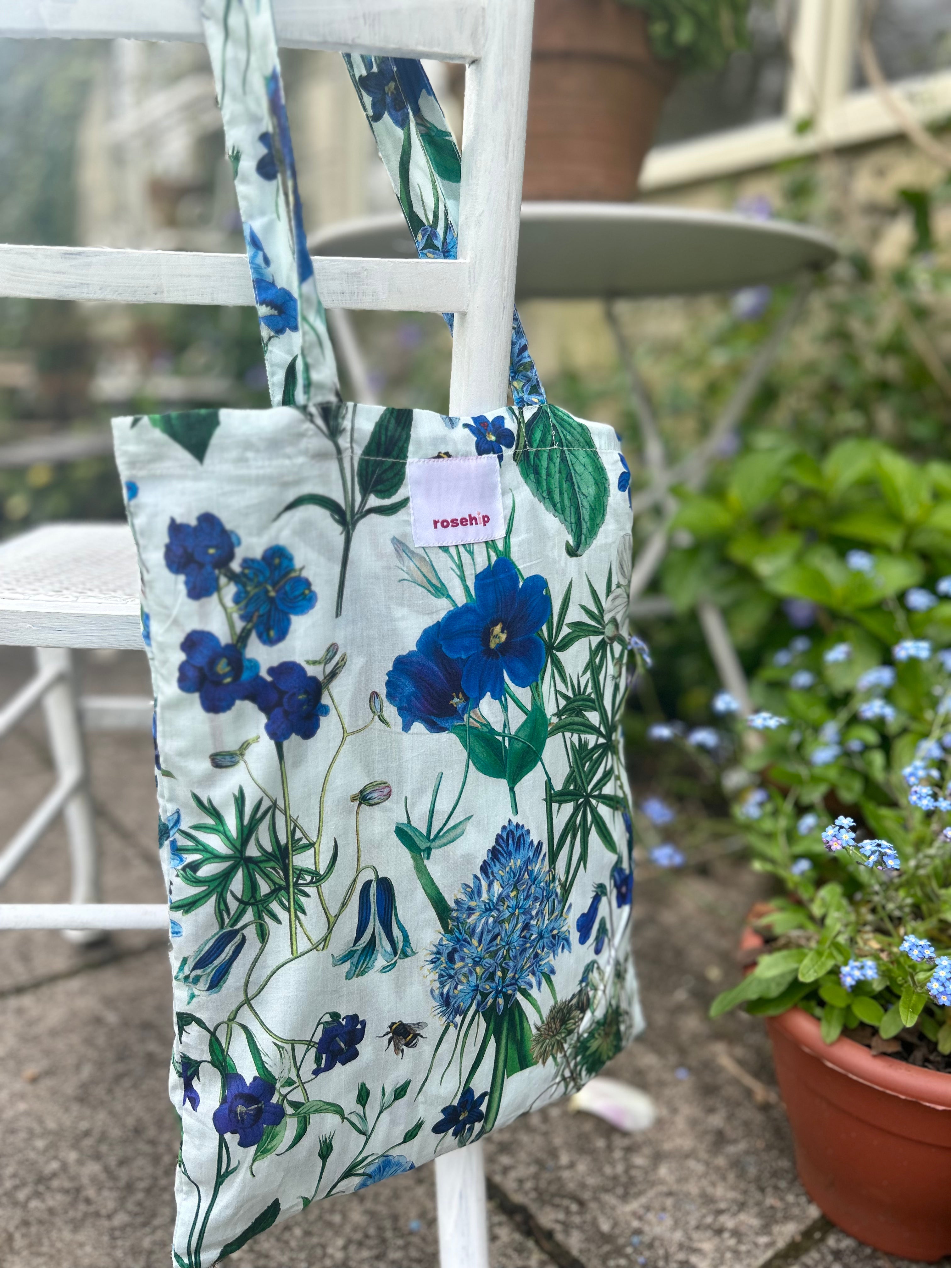 Rosehip Design Chloe Dress in Cobalt is a classic summer floral tiered dress in hues of blues with lovely long angel sleeves and side pockets, made from 100% soft Indian Cotton, packed in a matching bag.