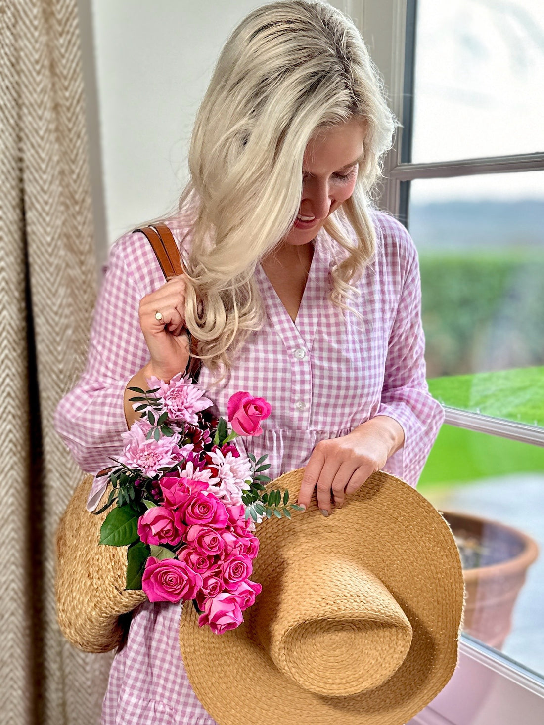 Rosehip Design Chloe Dress in Gingham Primrose is a classic summer floral tiered dress in a warm pink checked Gingham print with lovely long angel sleeves and side pockets, made from 100% soft Indian Cotton, packed in a matching bag.