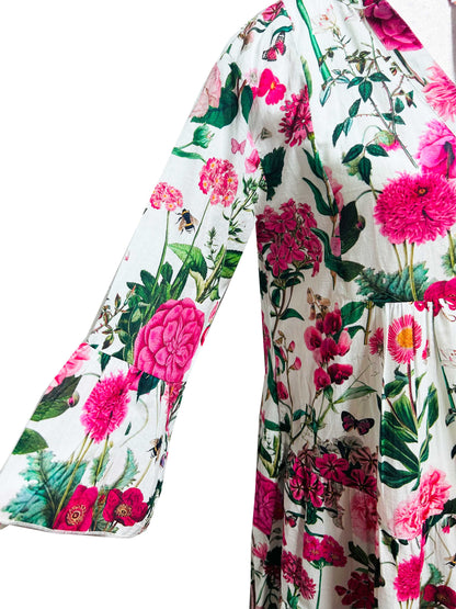 Rosehip Design Chloe Dress in Sweetpeas is a classic summer floral tiered dress printed in a vibrant mix of pinks, greens and reds with lovely long angel sleeves and side pockets, made from 100% soft Indian Cotton, packed in a matching bag.