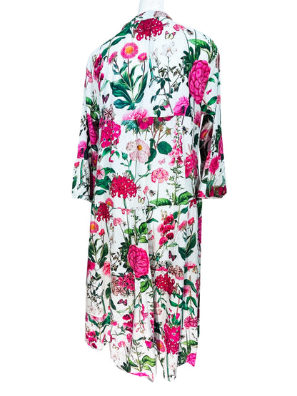 Rosehip Design Chloe Dress in Sweetpeas is a classic summer floral tiered dress printed in a vibrant mix of pinks, greens and reds with lovely long angel sleeves and side pockets, made from 100% soft Indian Cotton, packed in a matching bag.