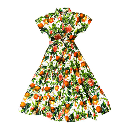 Rosehip Design Grace is a maxi dress made of Cotton Poplin. The Grace dress has buttons down the front, a tuck between tiers, short sleeves, and of course, side pockets.