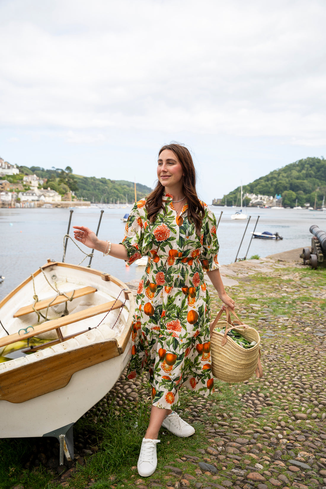 Rosehip Design Hannah Cotton Shirt in Blood Orange is a timeless blend of elegance and comfort. Made from soft cotton, it features a delicate frilled collar and intricate smocking on the sleeves for a touch of vintage charm. Designed for effortless styling, it pairs beautifully with the matching Bella Skirt.