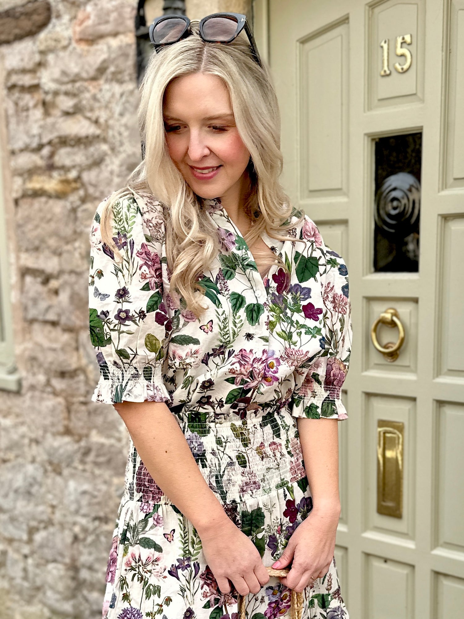 The Rosehip Design Hannah Cotton Shirt in Mallow is a timeless blend of elegance and comfort. Made from soft cotton, it features a delicate frilled collar and intricate smocking on the sleeves for a touch of vintage charm. Designed for effortless styling, it pairs beautifully with the Bella Skirt