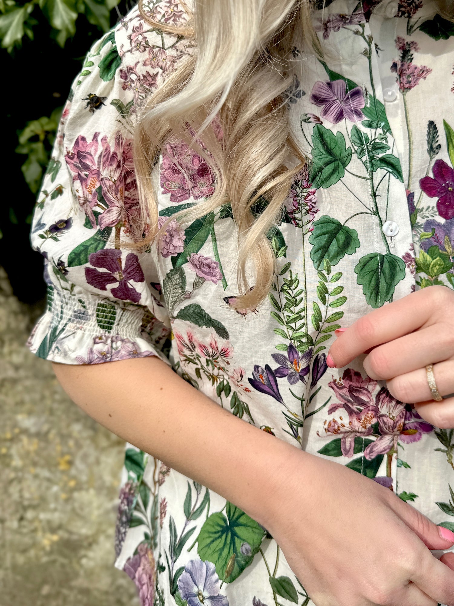 The Rosehip Design Hannah Cotton Shirt in Mallow is a timeless blend of elegance and comfort. Made from soft cotton, it features a delicate frilled collar and intricate smocking on the sleeves for a touch of vintage charm. Designed for effortless styling, it pairs beautifully with the Bella Skirt