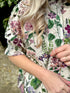 The Rosehip Design Hannah Cotton Shirt in Mallow is a timeless blend of elegance and comfort. Made from soft cotton, it features a delicate frilled collar and intricate smocking on the sleeves for a touch of vintage charm. Designed for effortless styling, it pairs beautifully with the Bella Skirt