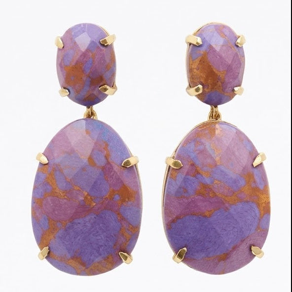 A pair of gold drop earrings featuring faceted oval purple and orange marbled stones, displayed on a clean white reflective surface.