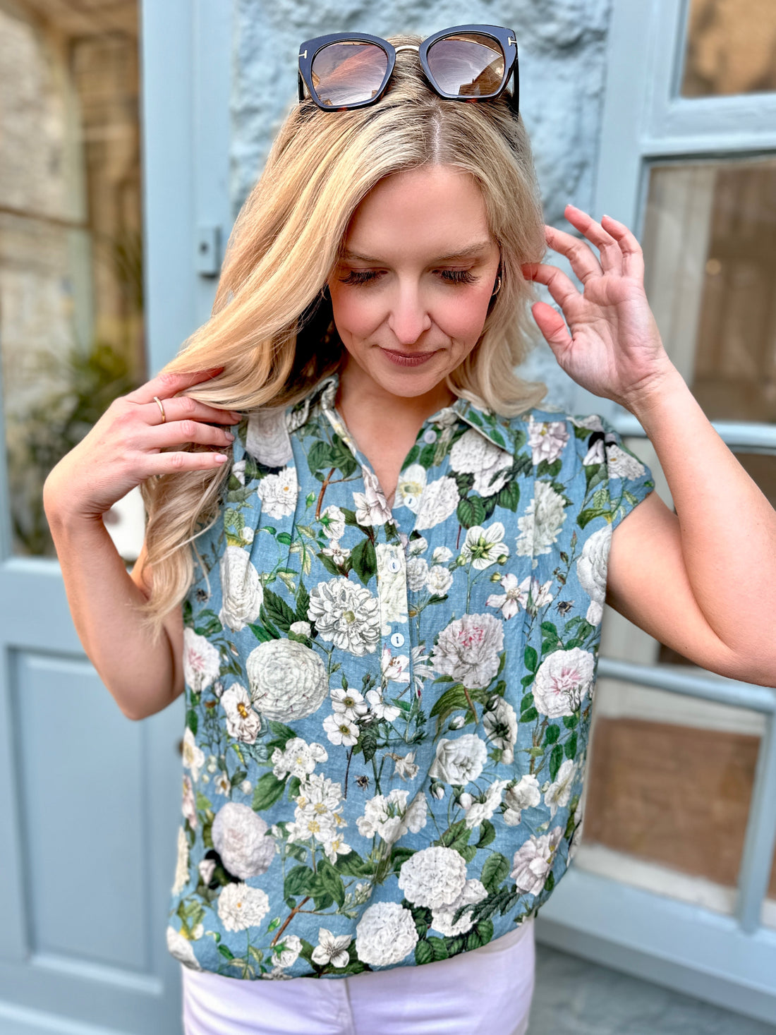Light, breathable, and effortlessly stylish — the Jemma Shirt is made from 100% pure linen and finished with a white Camelia Ocean print on beautiful ocean coloured background. Designed with a neat collar, a partial button front, and gently capped sleeves, it&