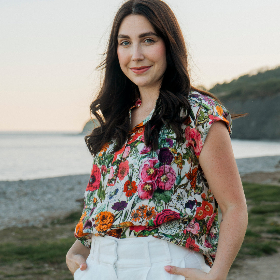 Light, breathable, and effortlessly stylish — the Jemma Shirt from Rosehip Design is made from 100% pure linen and finished with a bold Carnival design. Designed with a neat collar, a partial button front, and gently capped sleeves, it&