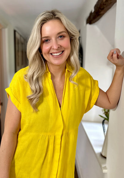 Rosehip Design Kate is an elegant summer dress made from 100% Linen in a bright and beautiful, sunny Yellow colour. It has short, cuffed sleeves, hidden buttons down the front, a few pleats under the bust and curved side slits. 