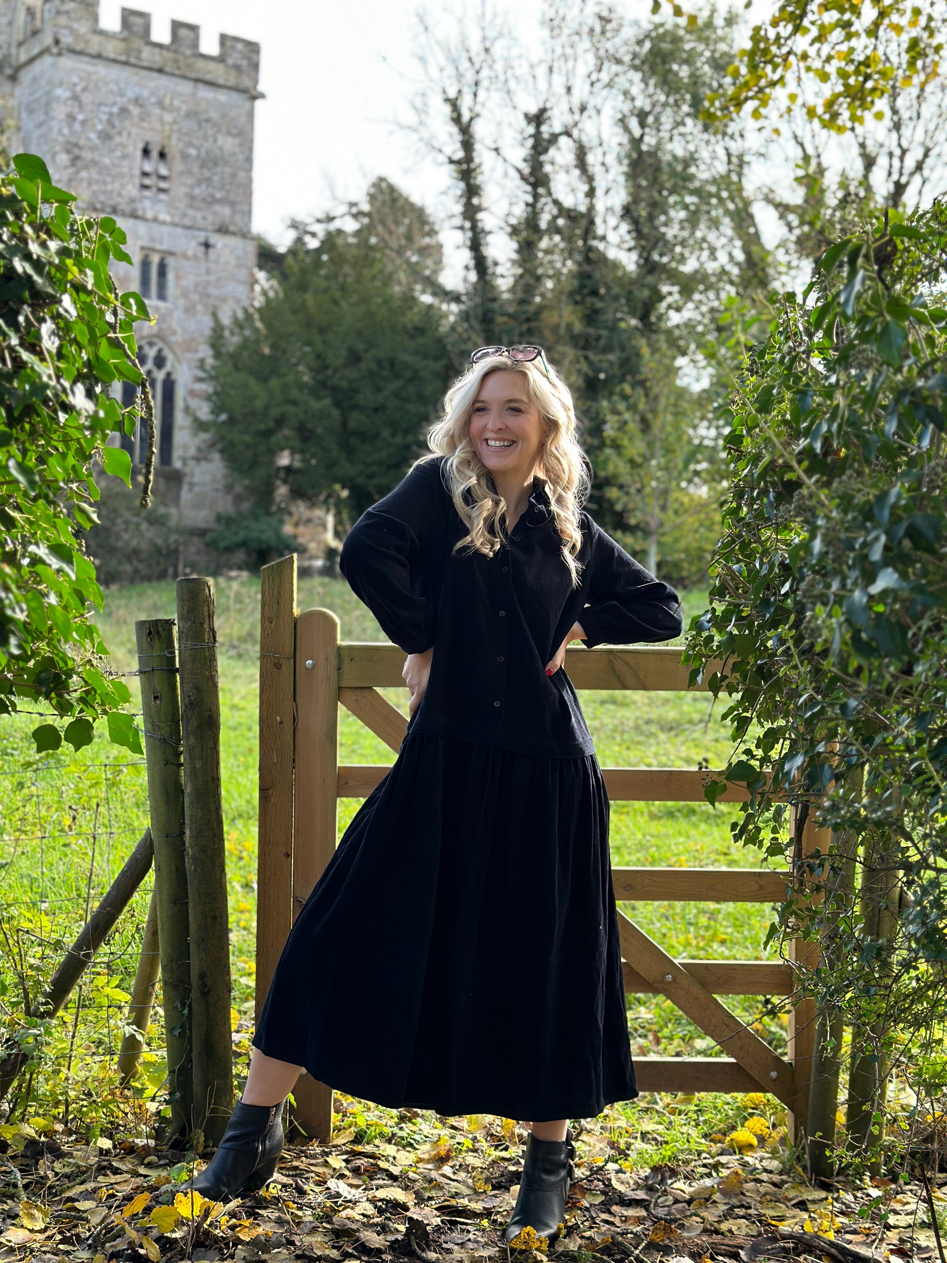 Rosehip Design Laura Dress - step into elegance with our Corduroy Maxi Dress, a perfect fusion of fashion and comfort in versatile Black. This dress boasts a gracefully dropped waist, creating a flattering and relaxed silhouette that effortlessly captures style with ease.