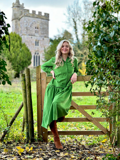 Rosehip Design Laura Dress - step into elegance with our Corduroy Maxi Dress, a perfect fusion of fashion and comfort in verdant Green. This dress boasts a gracefully dropped waist, creating a flattering and relaxed silhouette that effortlessly captures style with ease.