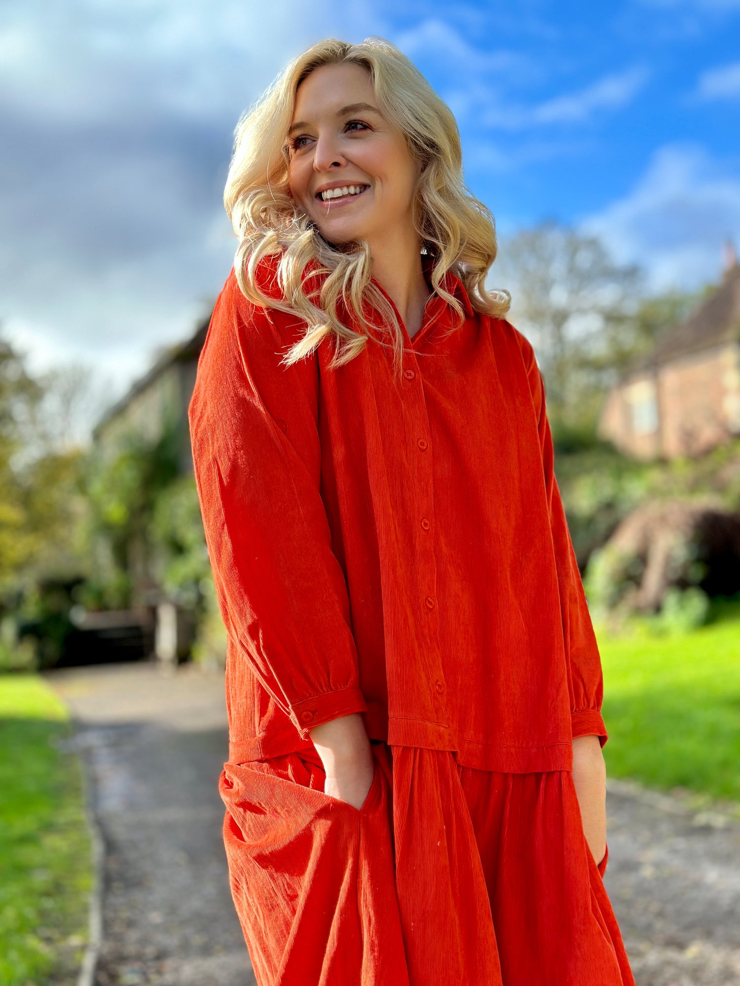 Rosehip Design Laura Dress - step into elegance with our Corduroy Maxi Dress, a perfect fusion of fashion and comfort in bold Orange. This dress boasts a gracefully dropped waist, creating a flattering and relaxed silhouette that effortlessly captures style with ease.