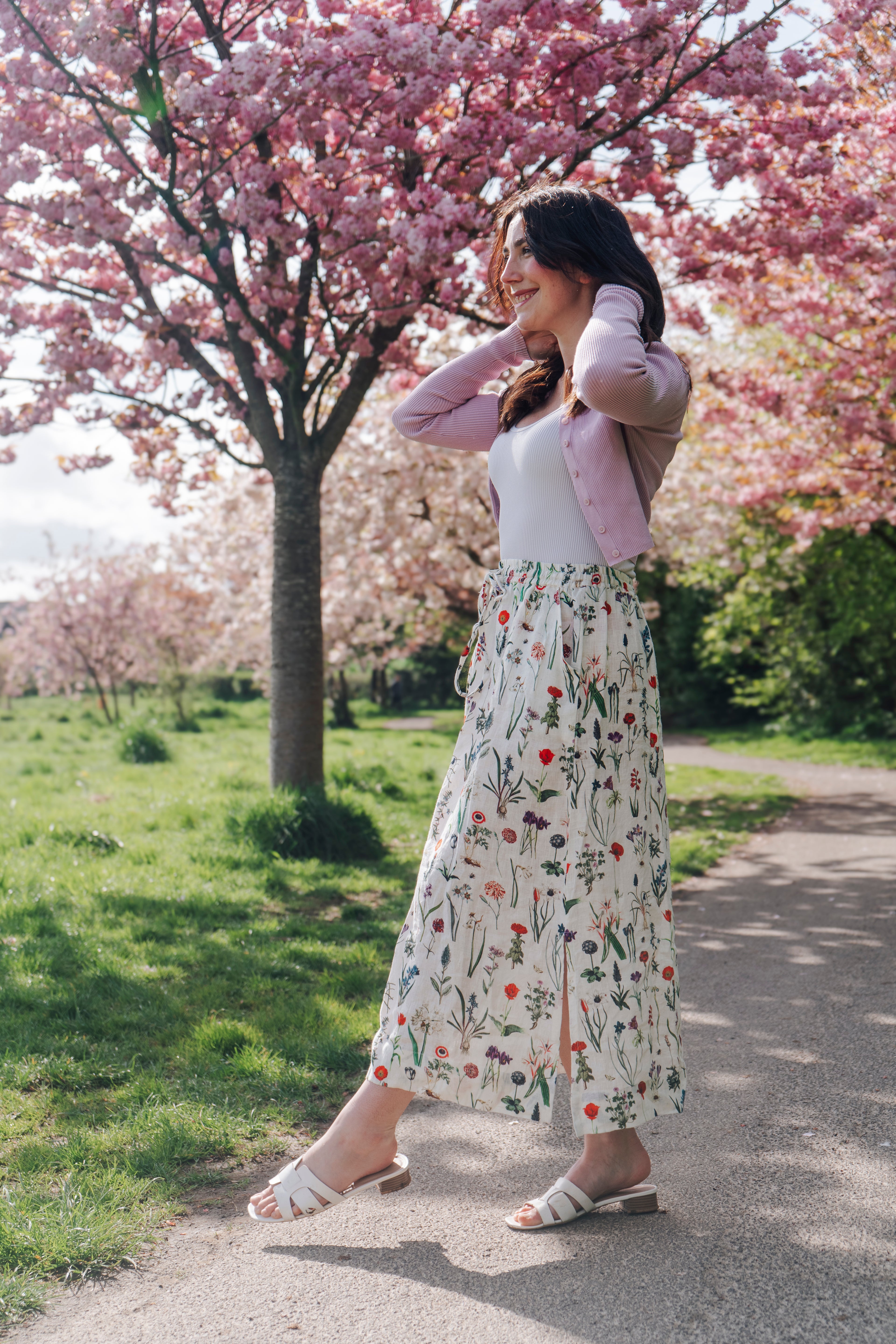 Crafted from 100% linen, the Rosehip Design Lilah Skirt in April design is a warm-weather staple with timeless appeal. Designed with a flattering classic cut, it features an elasticated waistband with a functional drawstring for a comfortable, adjustable fit. Subtle side slits add ease of movement and a touch of effortless elegance — perfect for sunny days, from morning markets to seaside strolls.