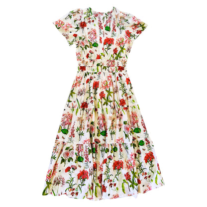 The Rosehip Design Margot cotton dress in Spring Blossom design is a beautifully feminine and effortless dress, designed for all-day comfort. Featuring a double elasticated waistband for a flattering fit, a flowing tiered skirt, and short capped sleeves, it blends elegance with ease. With the added practicality of pockets, it’s perfect for both casual outings and special occasions