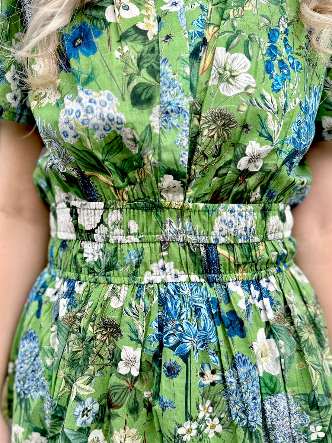 The Rosehip Design Margot cotton dress in Spring Greens is a beautifully feminine and effortless dress, designed for all-day comfort. Featuring a double elasticated waistband for a flattering fit, a flowing tiered skirt, and short capped sleeves, it blends elegance with ease. With the added practicality of pockets, it’s perfect for both casual outings and special occasions.