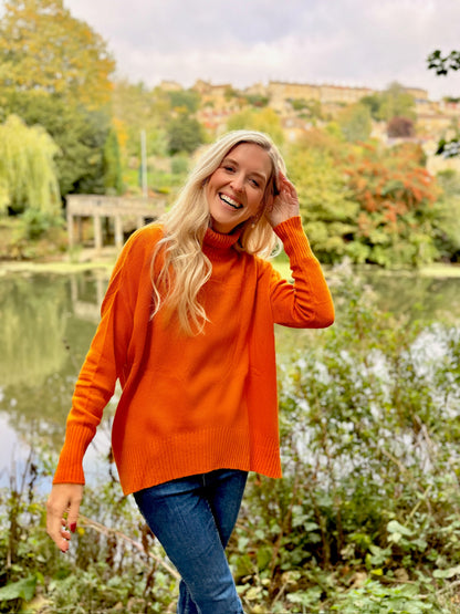 Stay effortlessly stylish and snug in this Rosehip Design woollen roll neck jumper, designed with a modern high-low hem that falls longer at the back for a flattering, easy silhouette. Crafted from soft, warming wool, it offers both comfort and elegance — perfect for layering on chilly days. The classic roll neck adds a touch of sophistication, while the relaxed fit makes it a versatile wardrobe staple you’ll reach for all season.